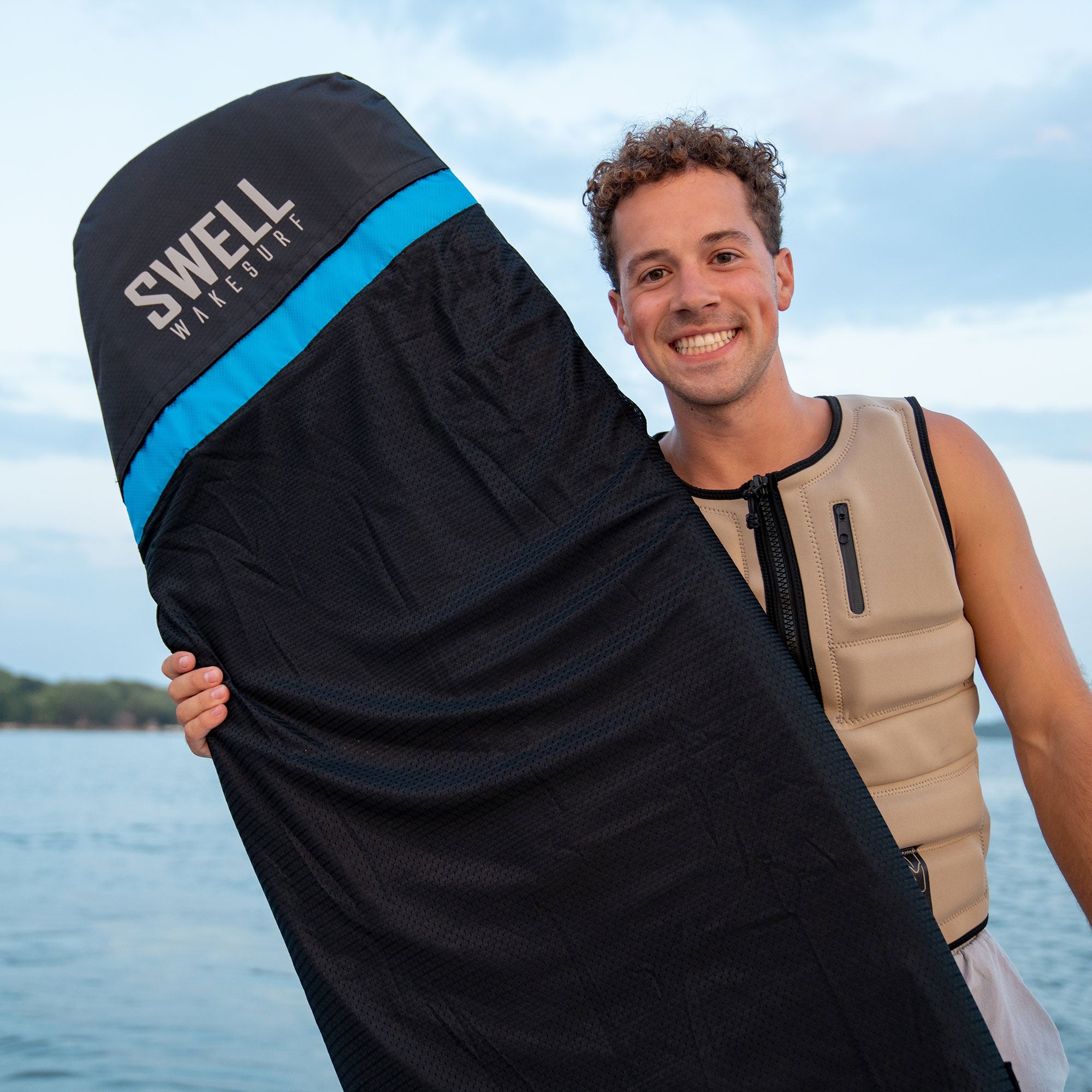 A man holding a SWELL Wakesurf Wakesurf Board Surf Sock for UV protection.